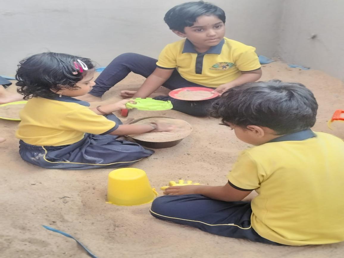 Children collaborating during outdoor sensory play